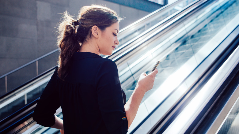 woman about to ride escalator