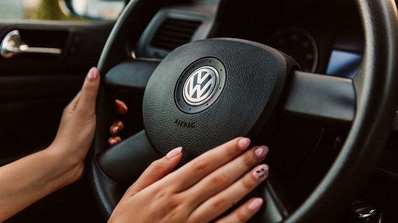Driver holding a Volkswagen steering wheel