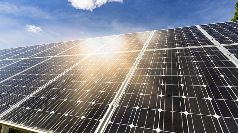 Multiple solar panels with white grid lines, installed on roof