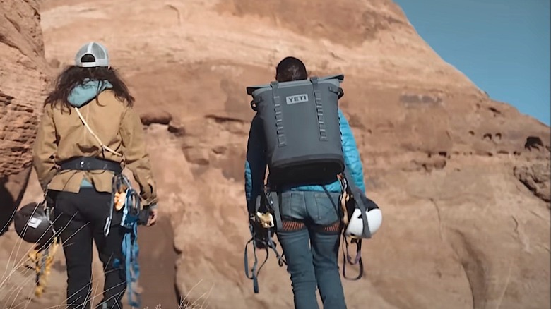 Person carrying Yeti Hopper cooler pack with loops prominently displayed