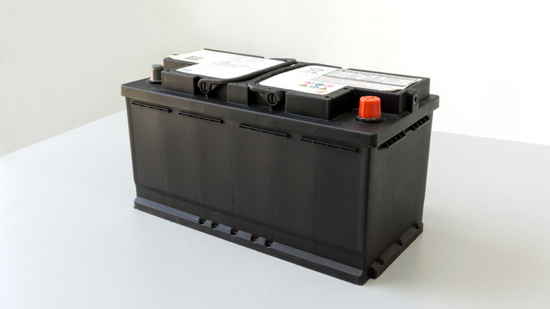 An old AGM battery with no branding on top of a white counter.