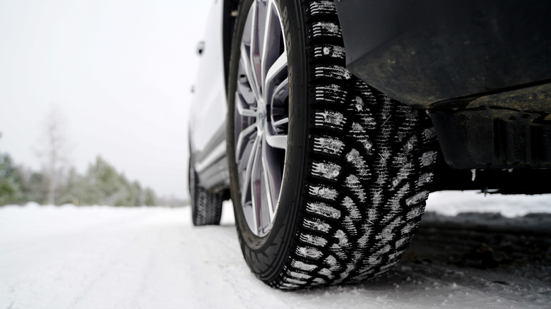 A winter tire with some snow on it