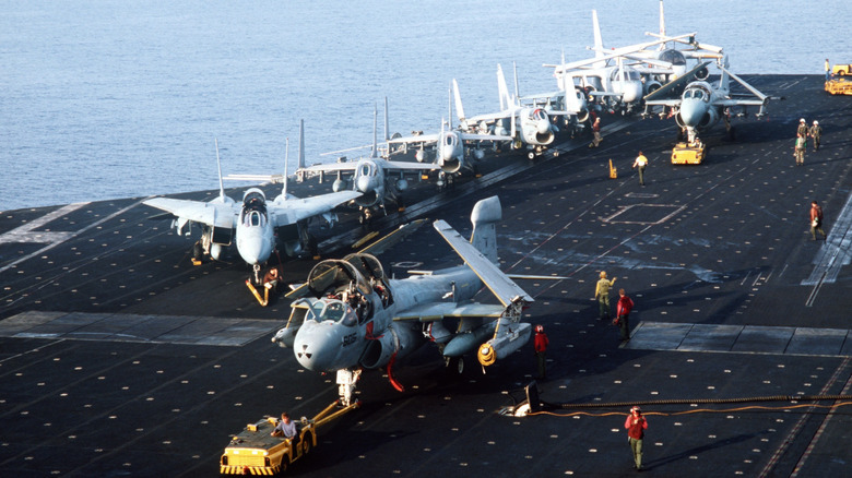 Aerial view of several aircraft on an aircraft carrier.