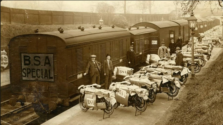 Old photo of BSA motorcycles waiting to be loaded onto a 