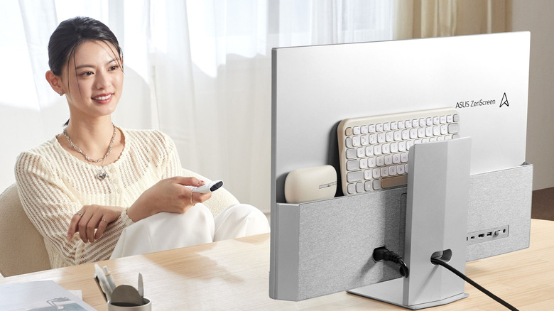 A woman using a Asus smart monitor on a desk