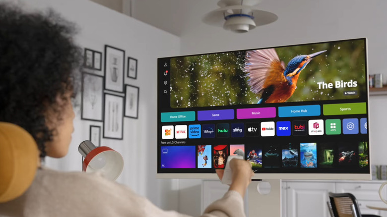 Woman using LG smart monitor with a remote