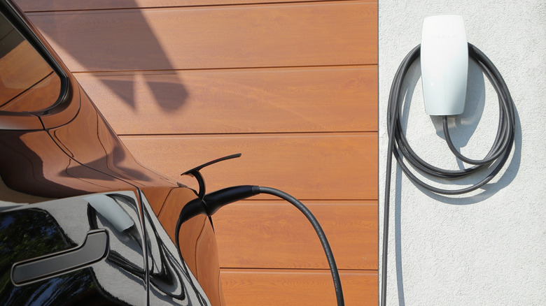 A Tesla charger charging an electric car.
