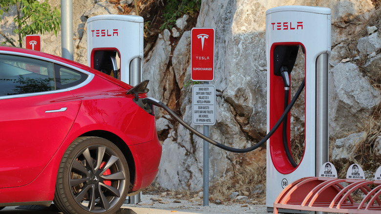 A Tesla car getting charged at a Tesla power station.
