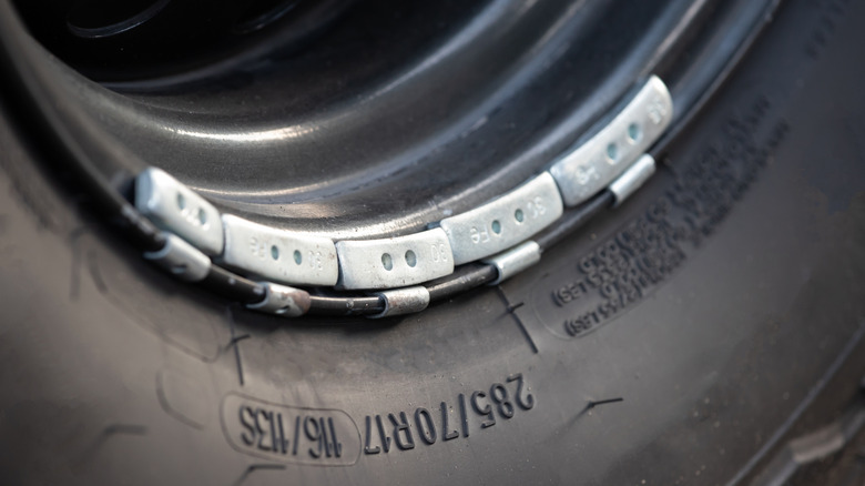 Close up of wheel weights on tire