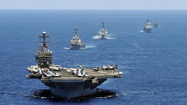 USS Abraham Lincoln leading a formation of ships in the Indian Ocean