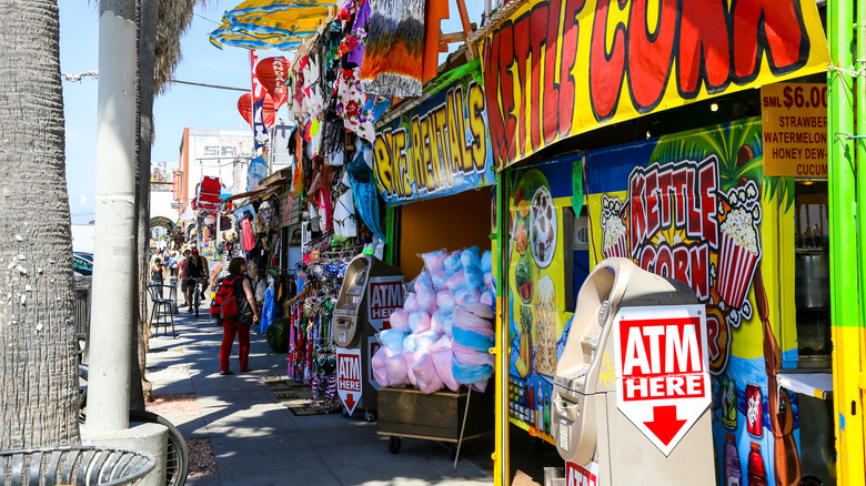 a beach boardwalk tourist area with ATMs
