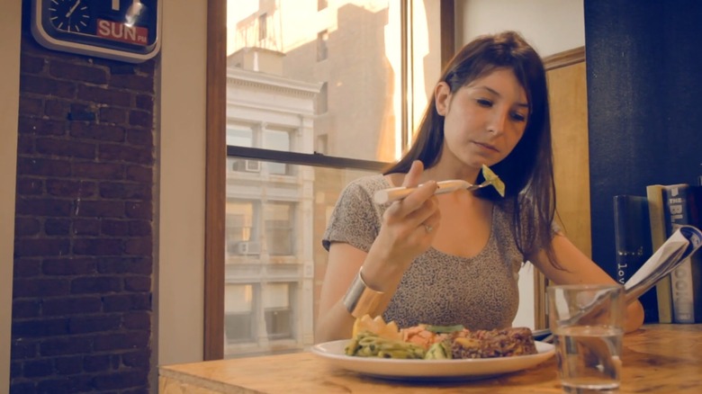 A Woman Eating With A Smart Fork