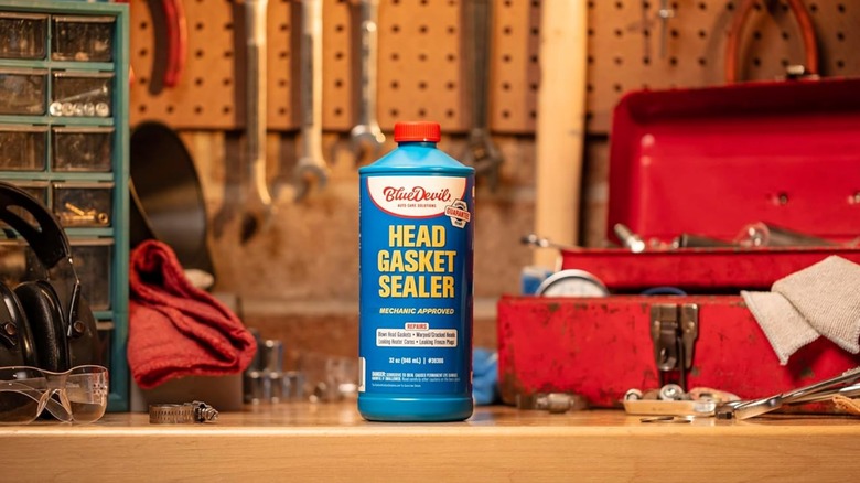 A bottle of BlueDevil head gasket sealer sitting on a work bench