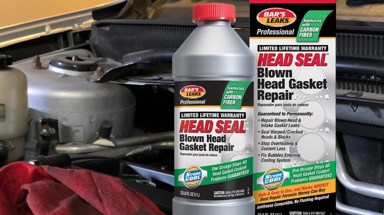 A bottle of Bar's Leaks head gasket sealer sitting in a car's engine bay