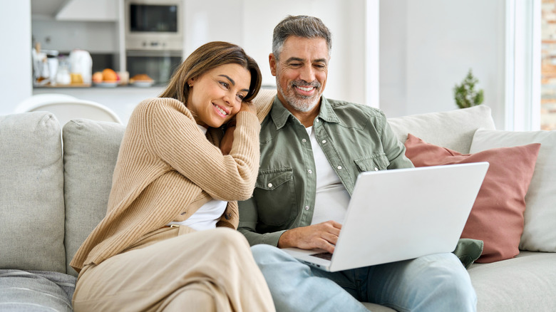 Two people watching content on a laptop
