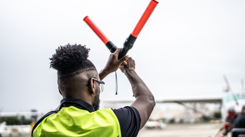 Close-up of an aircraft marshall giving signaling