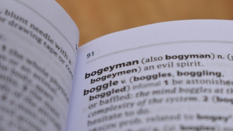 An open dictionary showing the definition of "Bogeyman" and "Boggle"