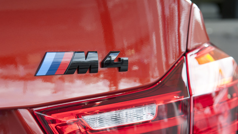 A close-up of the logo on a red F82 BMW M4