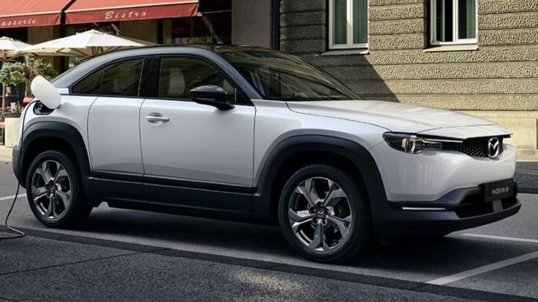 Parked Mazda MX-30 charging via on-street charger