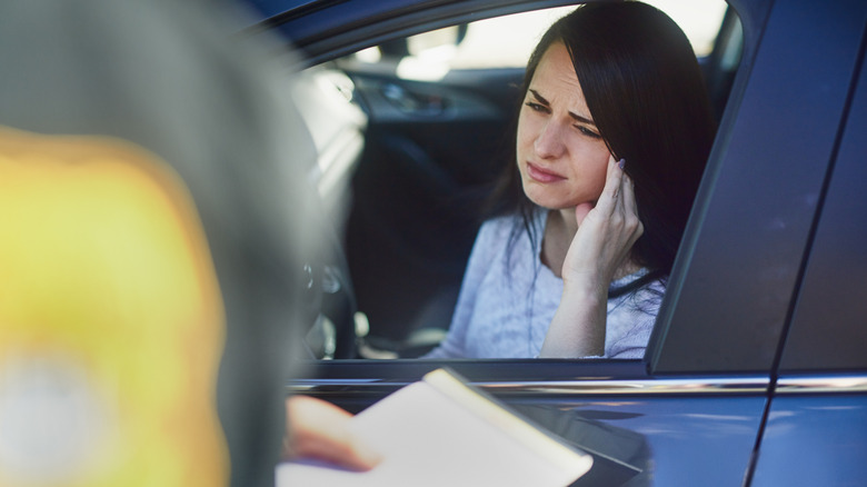 A lady driver stopped by the poice officer