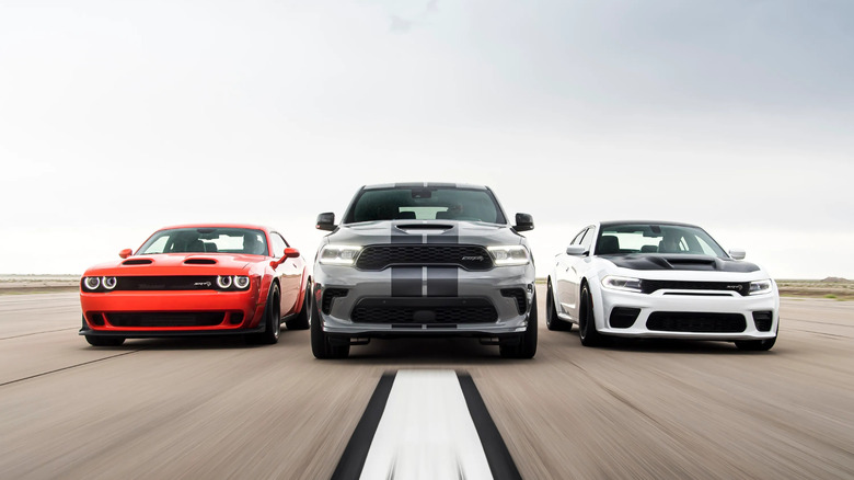From left: Dodge Challenger SRT Hellcat 170, Dodge Durango SRT, Dodge Charger SRT Hellcat, driving down runway, front-view