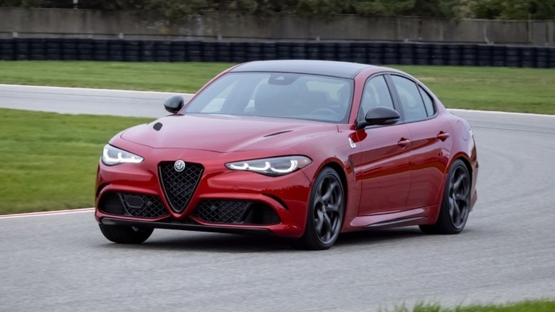 Front-left action shot of a 2024 Giulia Quadrifoglio around a turn