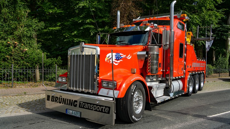 A red Kenworth W900L parked