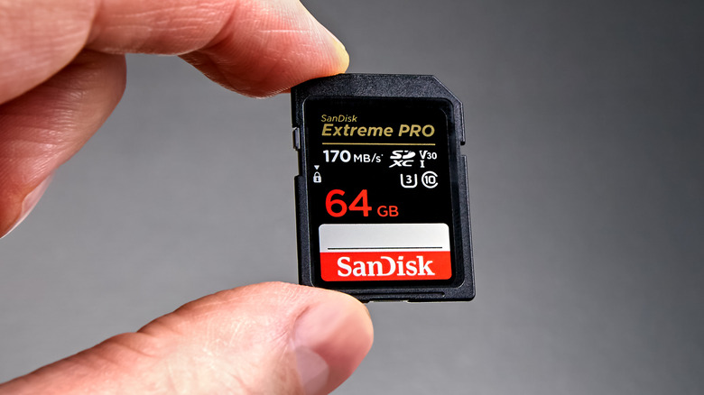 Close up of a hand holding SanDisk V30 SD card