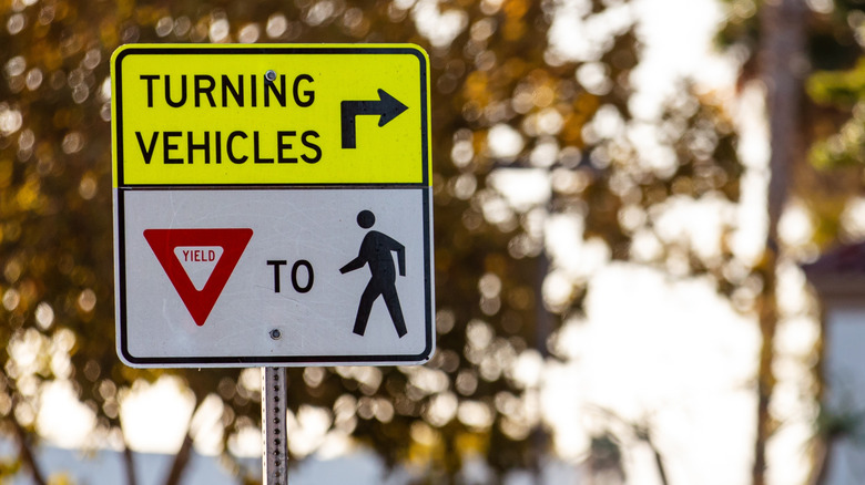 Turning Vehicles Yield to Peds sign in a neighborhood