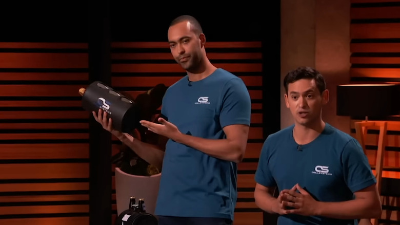 Brian talking while Chase holds and gestures towards cooler