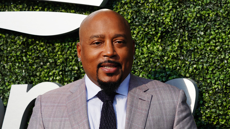 Daymond John in grey suit smiling