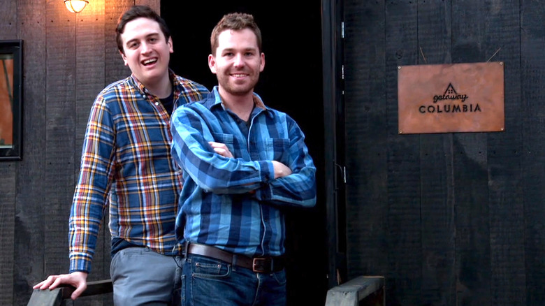 Getaway founders posing in front of a housing unit