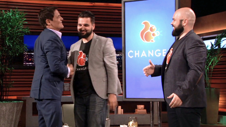 Mark Cuban shaking hands with Changed inventors after making a deal on Shark Tank