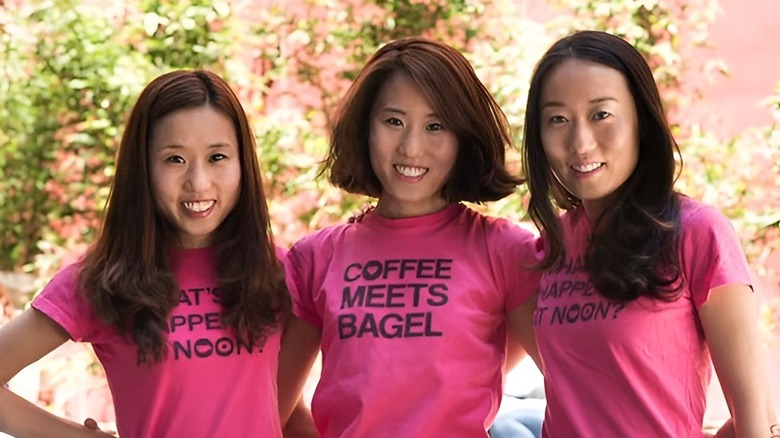 Kang sisters standing next each other and wearing pink shirts