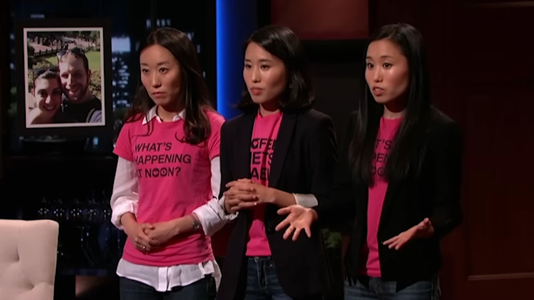 Kang sisters talking on Shark Tank next to display