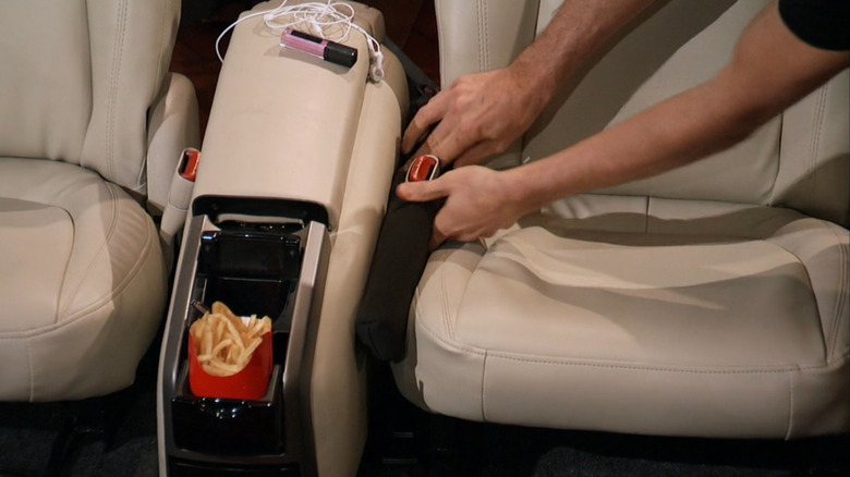 Marc demonstrating Drop Stop on a car seat set on Shark Tank