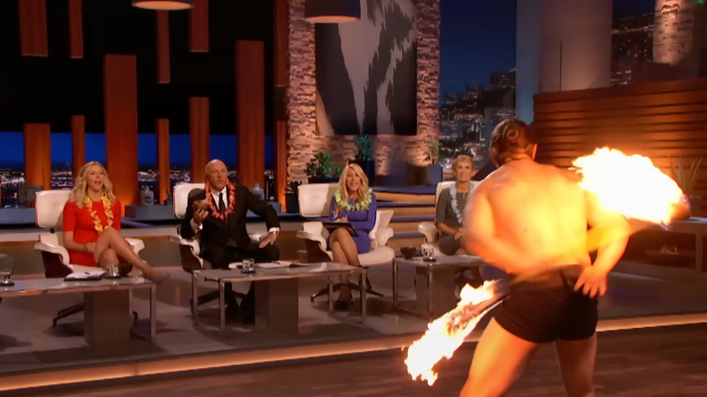 Investor panel intensely watching fire dancer on Shark Tank