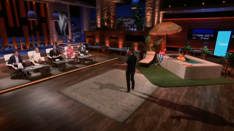 Bunim standing in front of and presenting to the sharks on Shark Tank