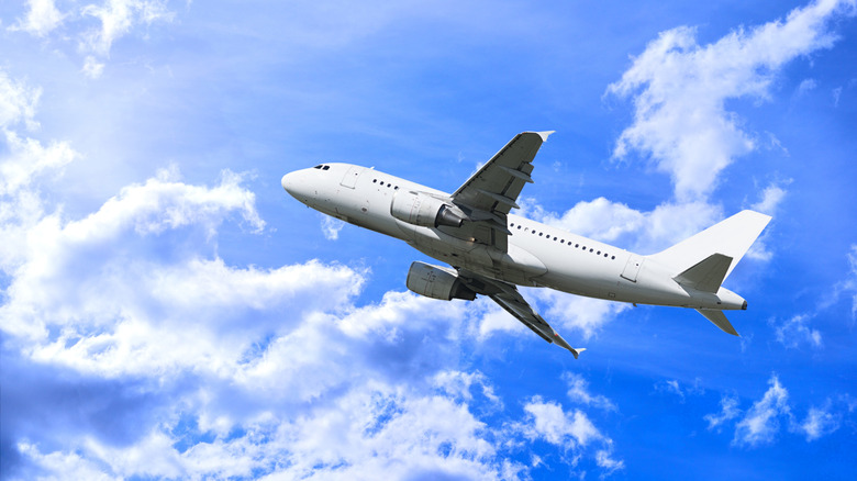 Airplane flying among clouds.