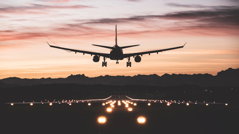 Airplane just about to touch down on the runway.