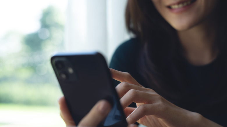 Close up of person using smartphone.