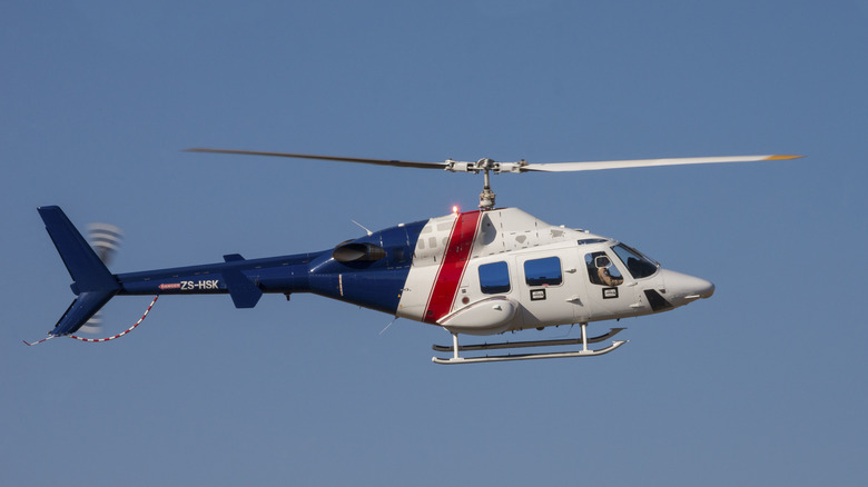 A Bell 222 flying in clear blue skies