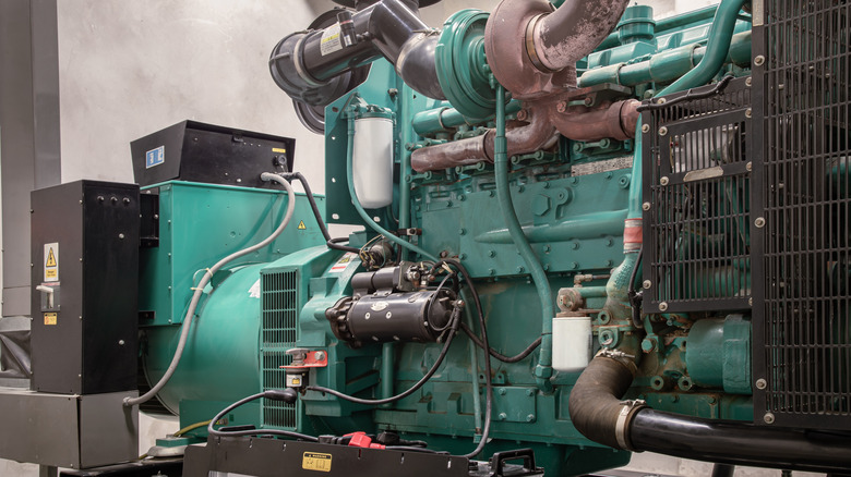 A teal-colored diesel engine generator