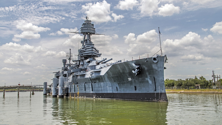 A docked dreadnought battleship on a cloudy day
