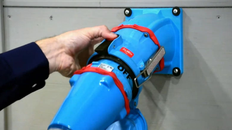 A blue Meltric DSN150 being plugged into a receptacle.