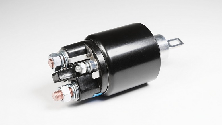 Black starter solenoid on white background