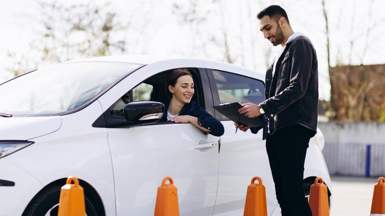 Woman passing driving test at driving school