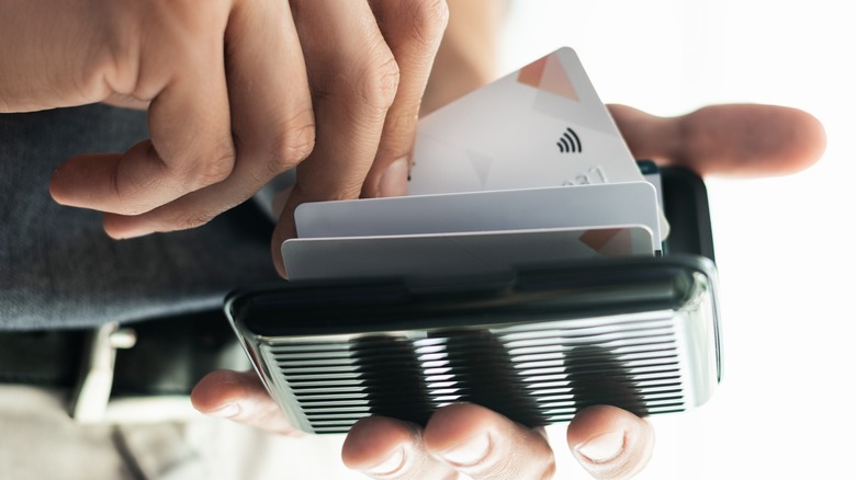 Man slips card into card holder