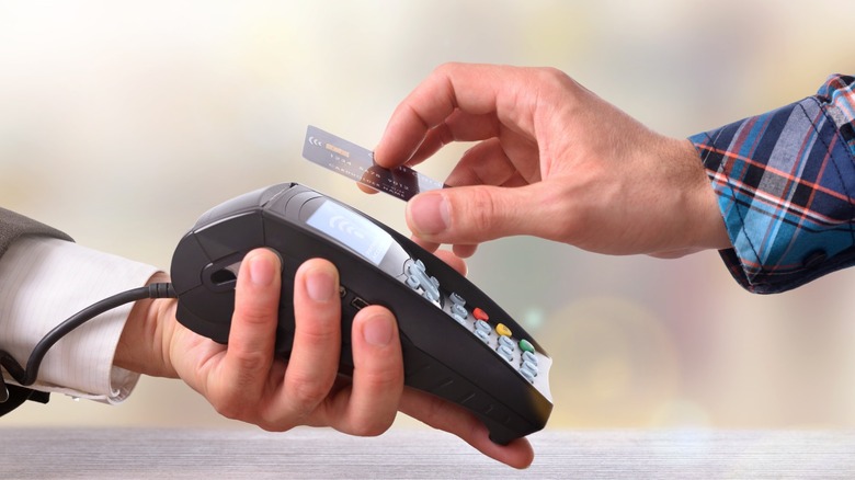 Person paying merchant through a card