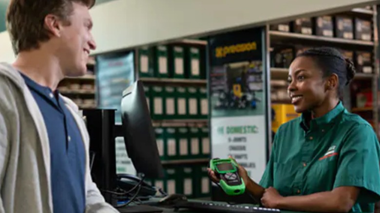 an o'reilly auto parts employee helping a customer diagnose a check engine light
